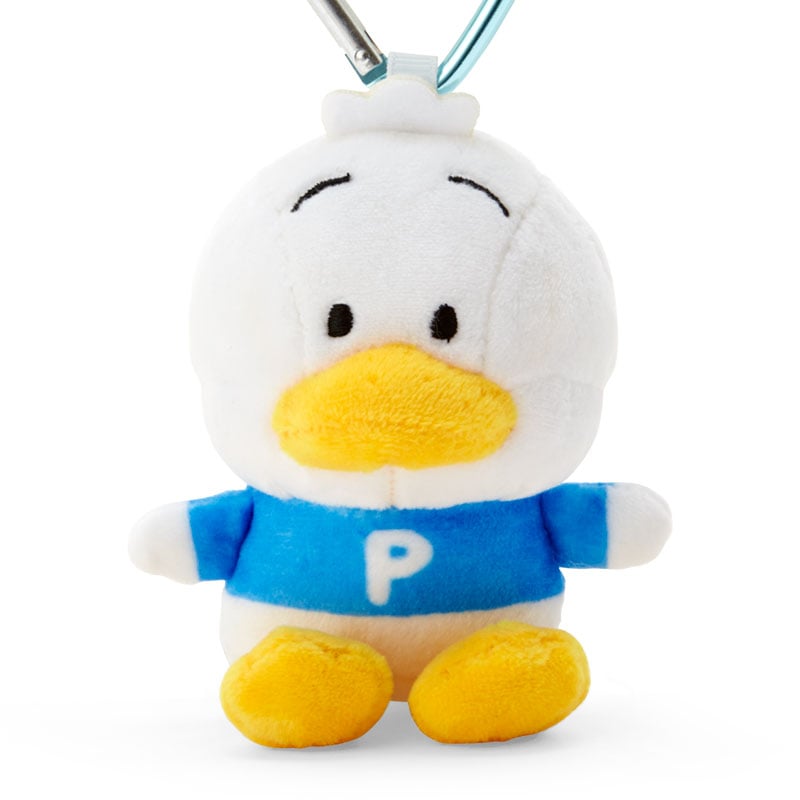 Plush mascot attached to backpack zipper in NYC casual streetwear setting