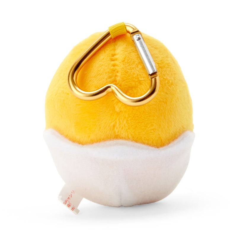 Side view of the Gudetama keychain, highlighting its soft fabric and stitching.