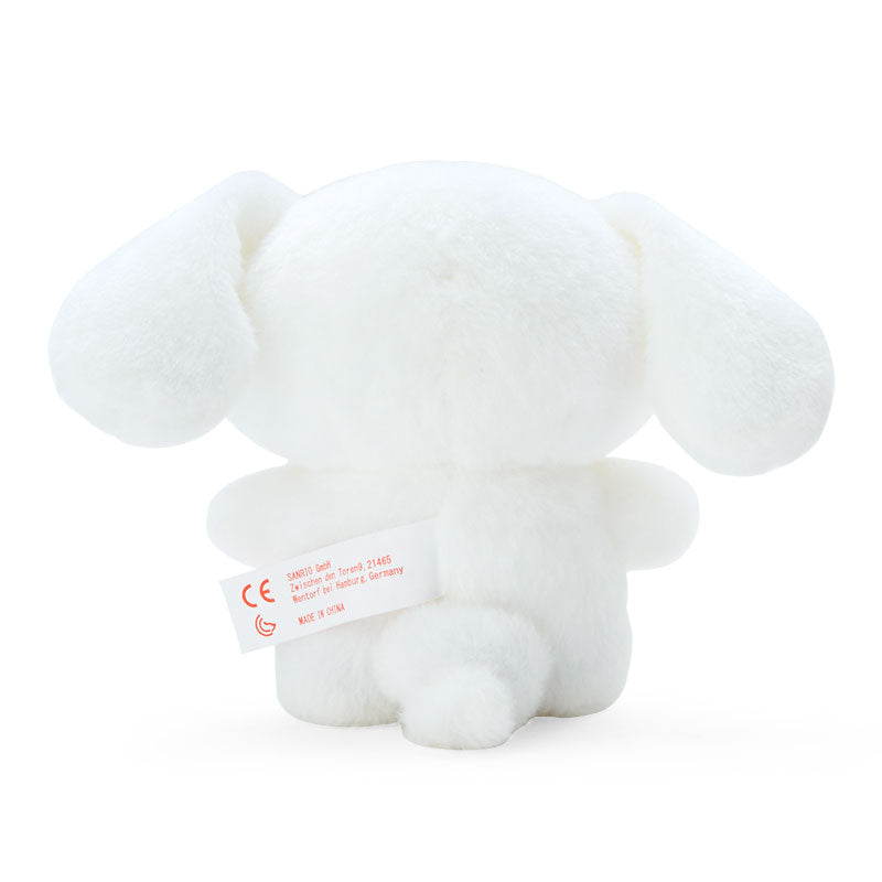 Front view of standing plush displayed on a white bookshelf