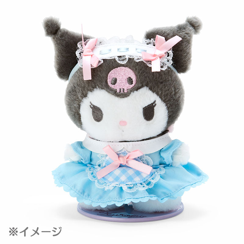 Kuromi plush doll displayed on a wooden desk with books