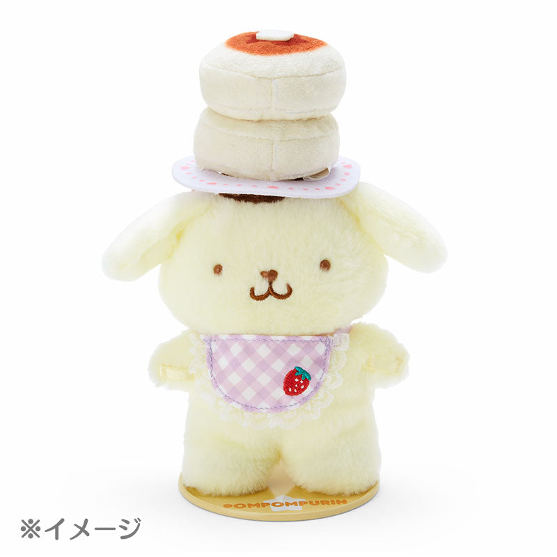 Pompompurin plush toy standing on a desk with magnetic feet