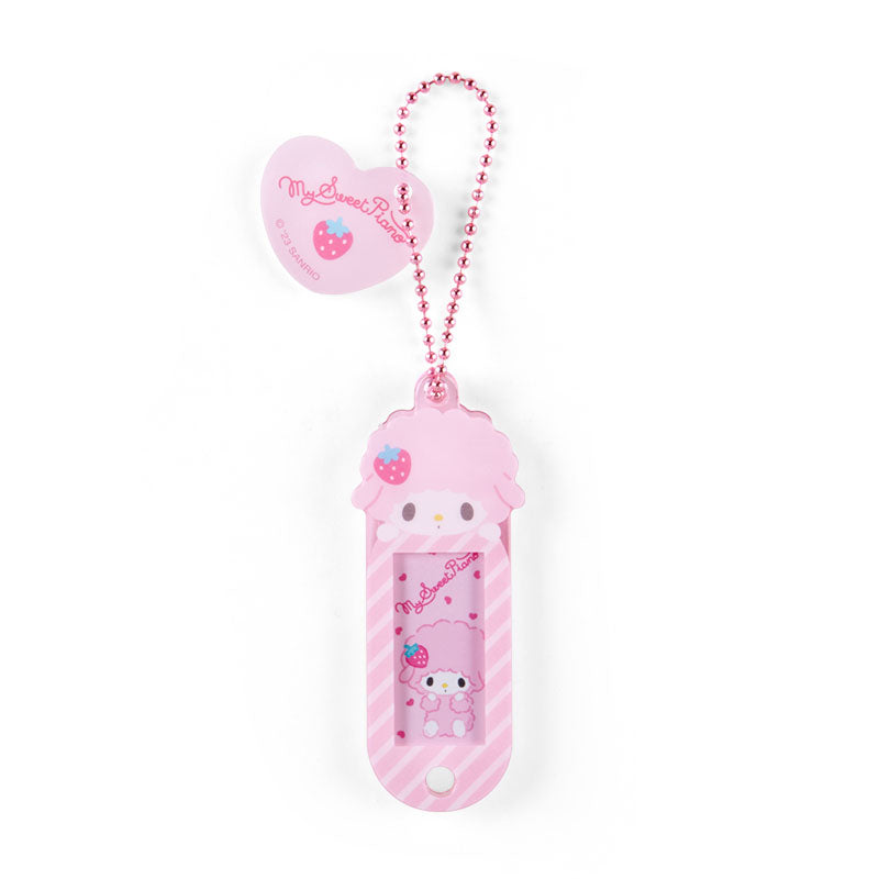 Close-up of customizable Sanrio bag charm with a cheerful design.