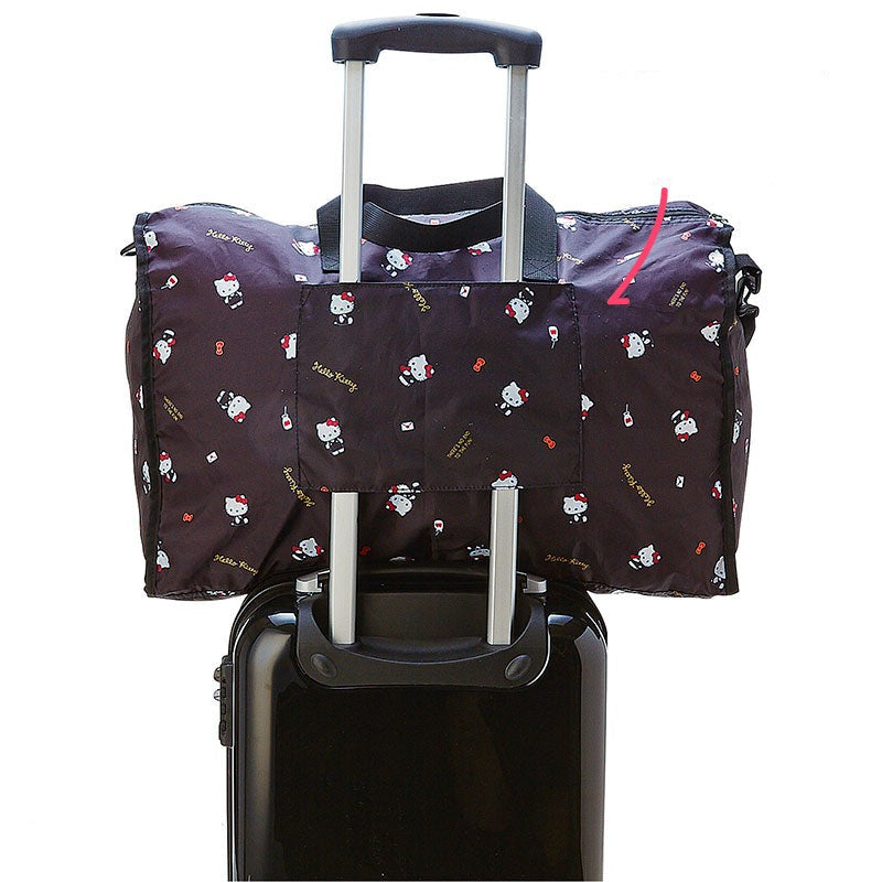Kuromi foldable weekender bag being carried with its adjustable shoulder strap.