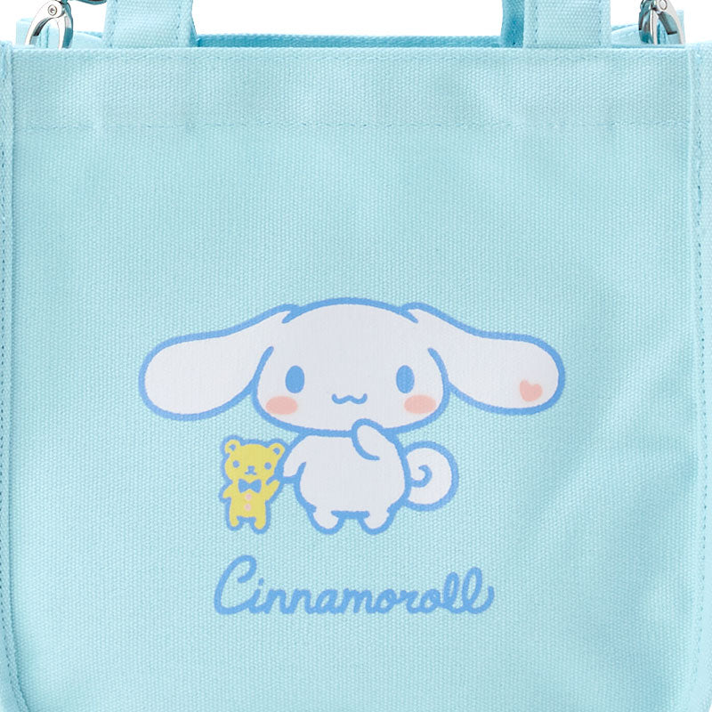 Sanrio Cinnamoroll tote bag held by a model in a park setting