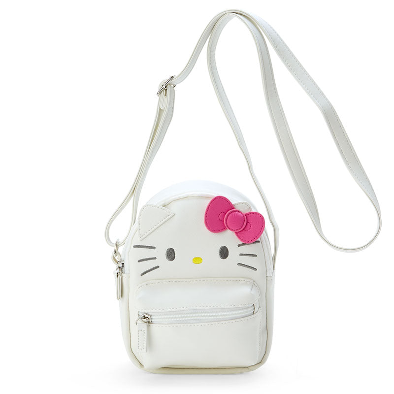 Hello Kitty mini bag worn crossbody with city skyline in background