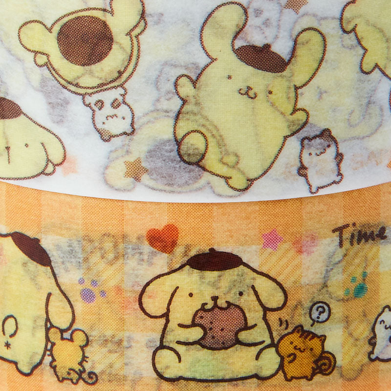 Hand holding Pompompurin tape while decorating a letter
