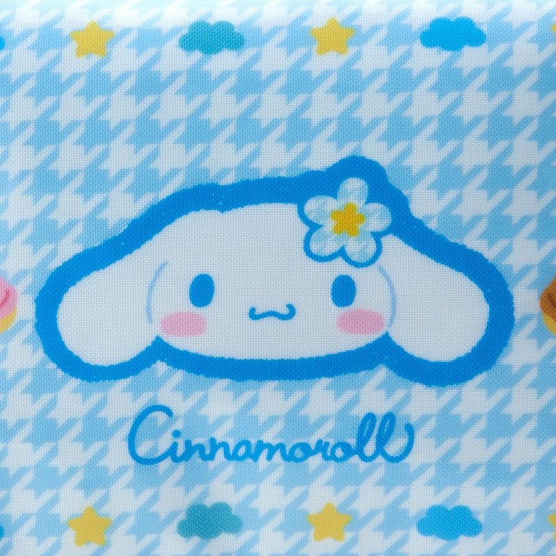 Cinnamoroll zipper makeup bag with beaded charm, lying on a pastel-colored background