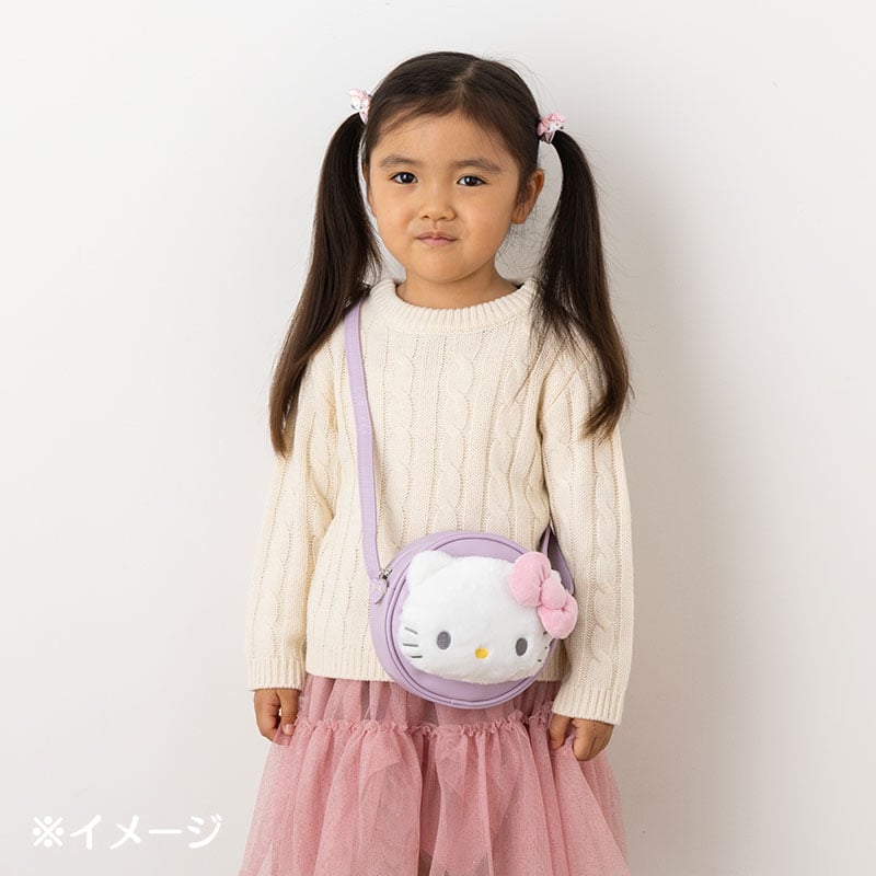 Plush crossbody Hello Kitty bag being carried over the shoulder
