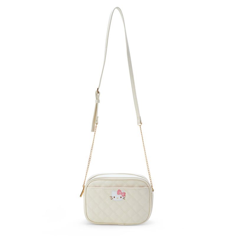Close-up of Hello Kitty quilted bag showing embroidered face and gold zipper