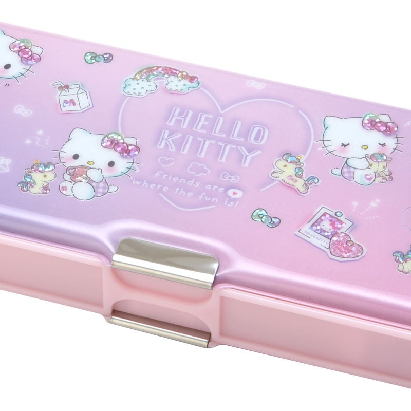 Open Hello Kitty pencil case box displaying compartments and mini sharpener