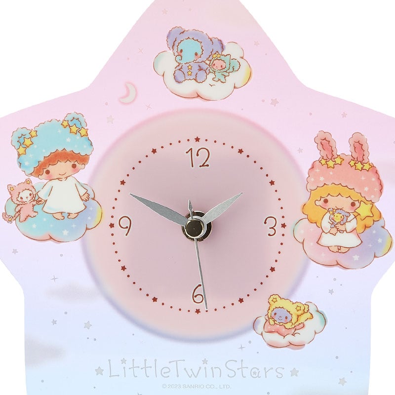 Front view of the star-shaped clock showing twinkling stars and adorable characters