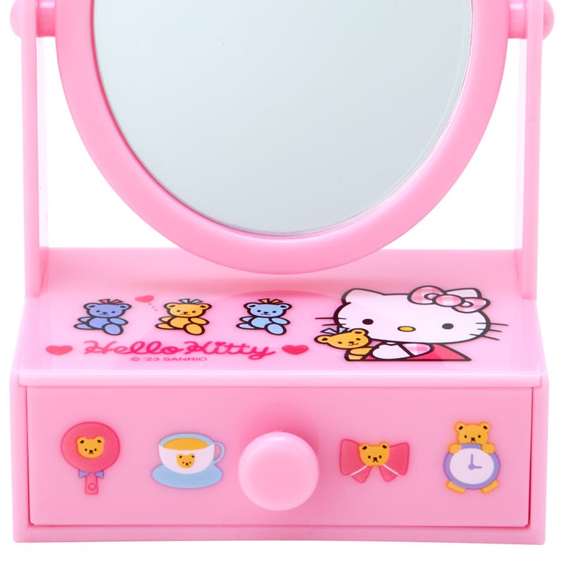 Makeup vanity setup with Hello Kitty mirror on bedroom dresser