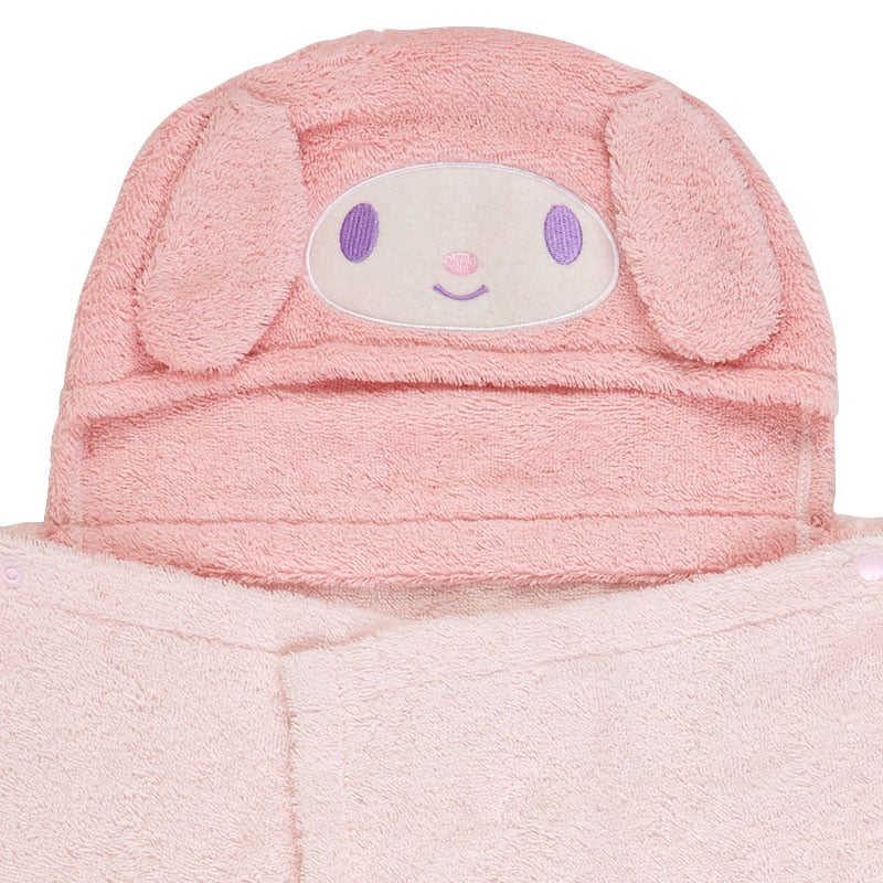 My Melody hooded bath towel draped over a baby chair, showing floral print and embroidered hood
