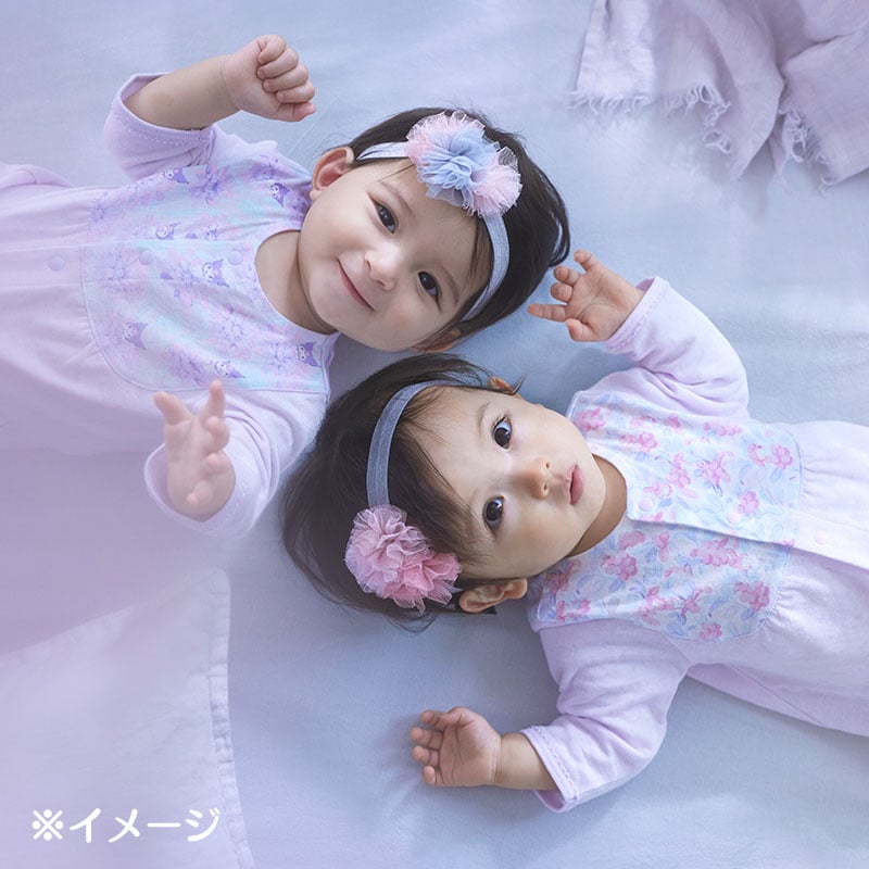 Baby wearing the convertible gown in a cozy nursery setting