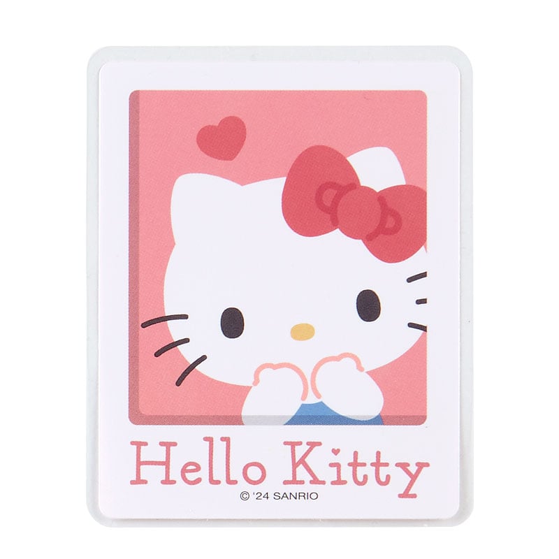 Close-up of Hello Kitty sticker on a laptop lid showcasing colorful design