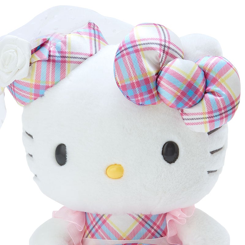 Close-up of the Hello Kitty plushs face, featuring ABS eyes and nose, and a pink ribbon.