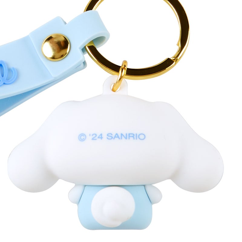 Cinnamoroll Baby Series keychain displayed on pastel pink background
