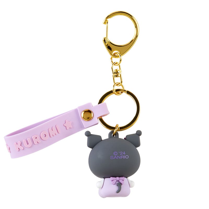 Lifestyle shot of cute accessories including Kuromi keychain on a city commute tote