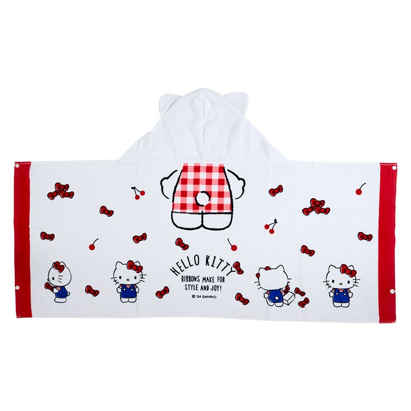 Child playing in the backyard wrapped in a soft hooded towel featuring Hello Kitty design