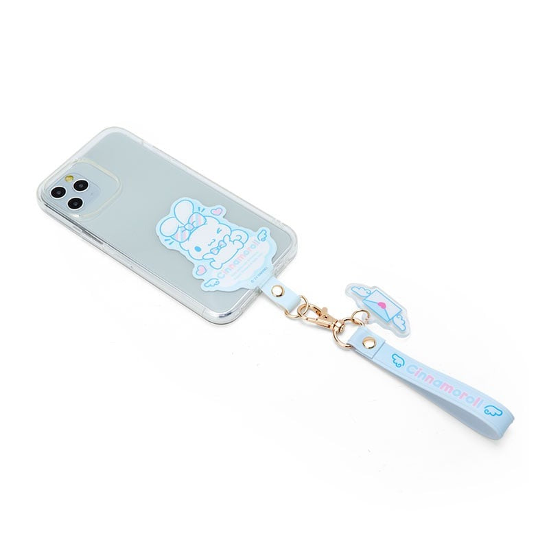 Cinnamoroll phone strap attached to smartphone, showing pastel bowtie detail