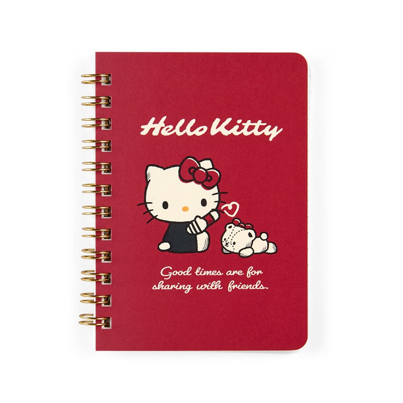 Hello Kitty notebook open on a desk with a cup of coffee nearby