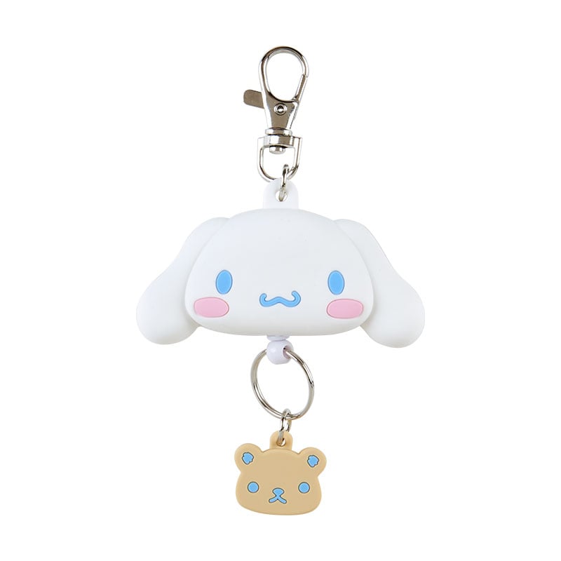 Front view of Cinnamoroll plush keychain badge reel clipped to backpack
