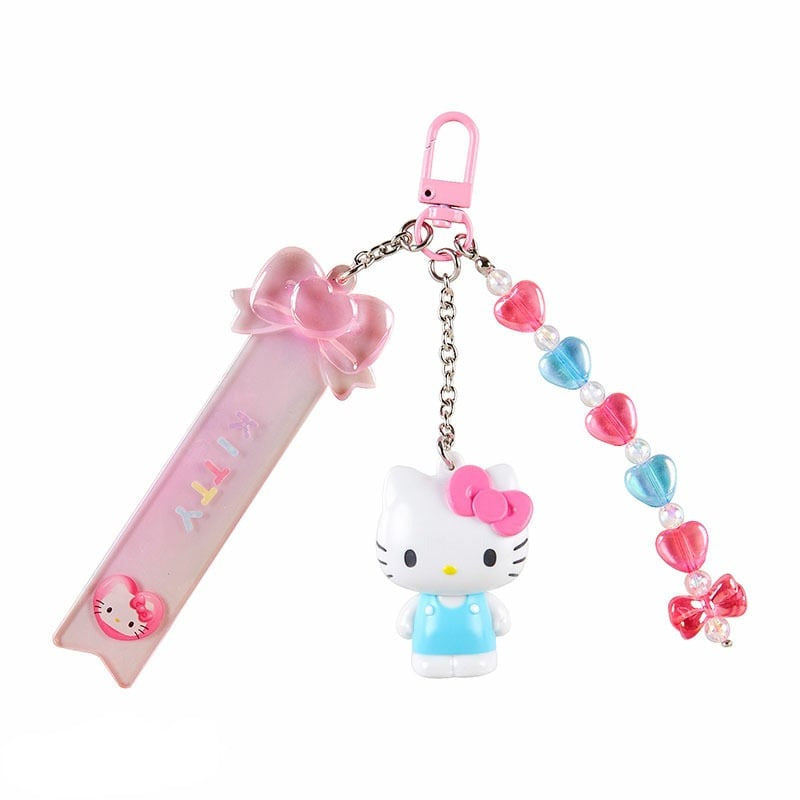Hello Kitty keychain being customized with alphabet stickers