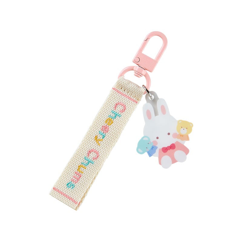Colorful Sanrio character logo keychain with embroidered names, attached to a tote bag