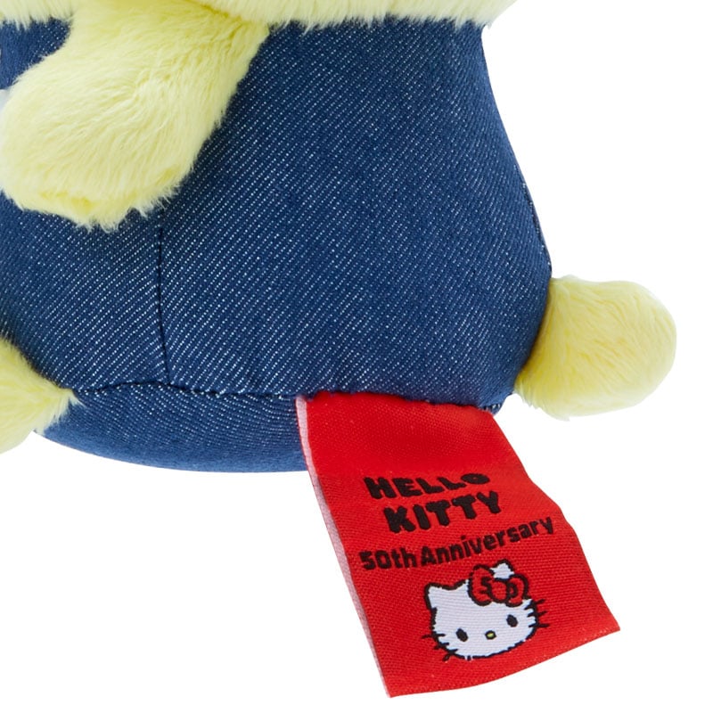 Pompompurin keychain plush attached to a stylish handbag.