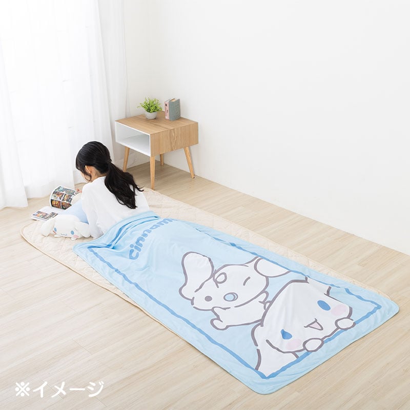 Person relaxing with the lightweight throw blanket at the beach