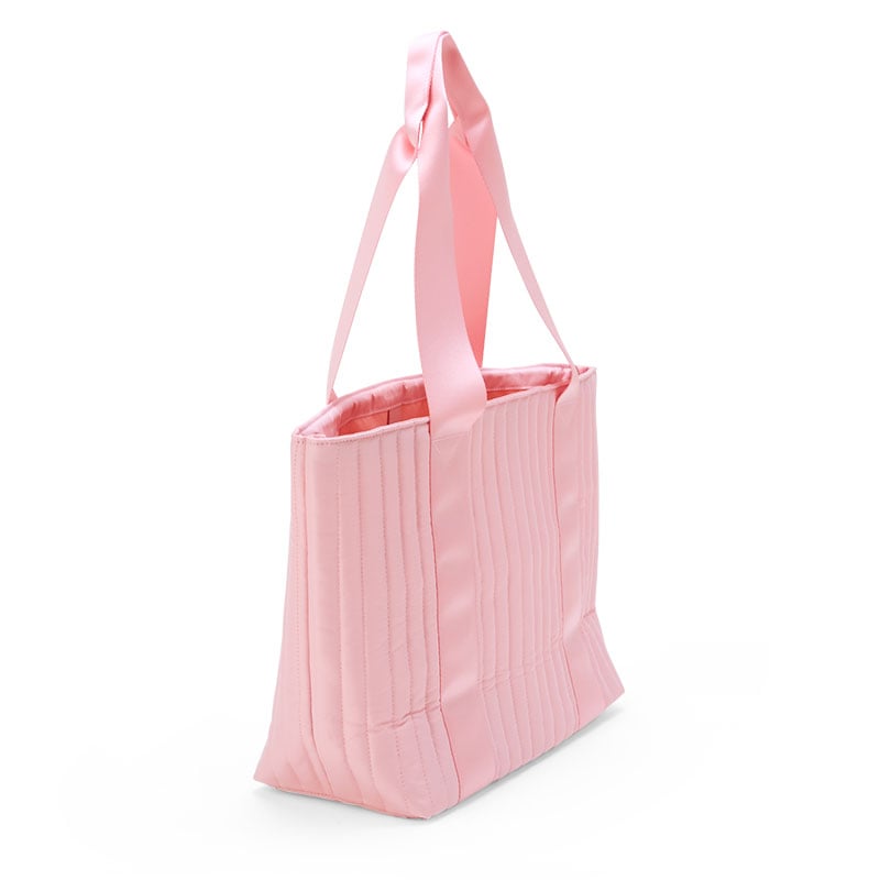 Hello Kitty tote bag being used in a casual outdoor setting.