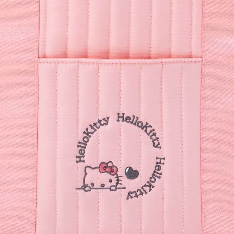 Hello Kitty tote bag being used in a casual outdoor setting.