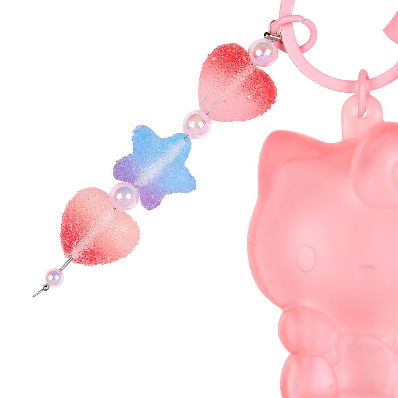 Hello Kitty keychain plush attached to a stylish backpack.