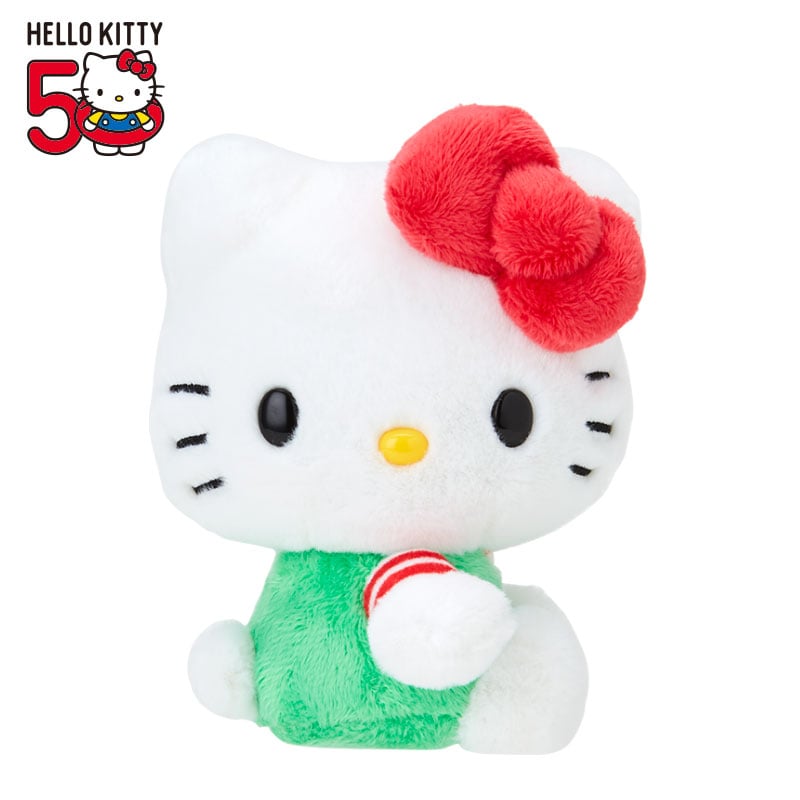 Close-up of Hello Kitty plush mascot with embroidered details in green overalls
