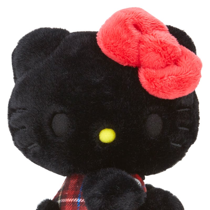 Black tartan Hello Kitty mascot plush held in hand to show size and embroidery details.