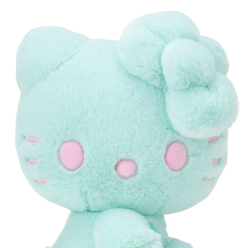 Hello Kitty plush displayed on a shelf with other collectibles