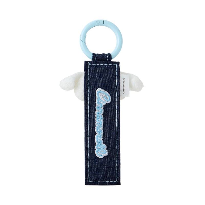 Cinnamoroll keychain attached to a pair of jeans, demonstrating its use as a fashion accessory.