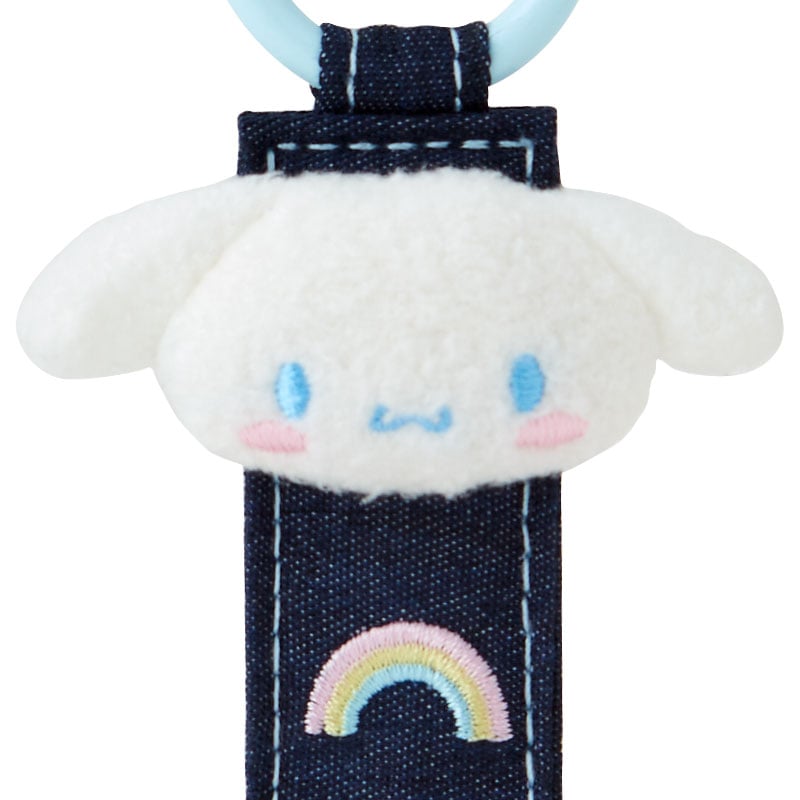 Sanrio Cinnamoroll Denim Patch Keychain on a desk, surrounded by other Sanrio desk accessories.