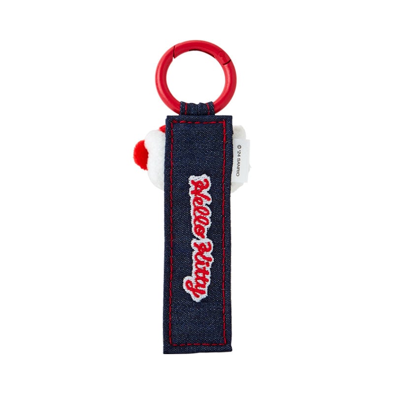 Side view of Sanrio keychain clipped to a denim tote, showing clasp and mascot