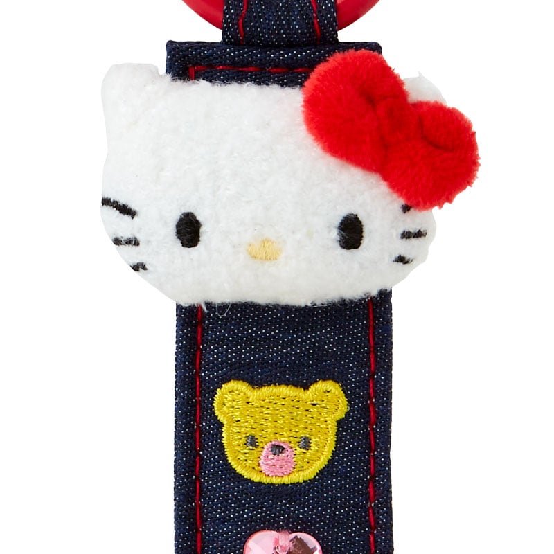 Detailed close-up of embroidered patches on the plush hello kitty keychain