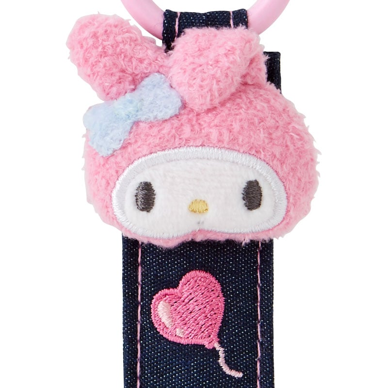 My Melody denim patch keychain with chenille textures and embroidered name tag, displayed on a table.