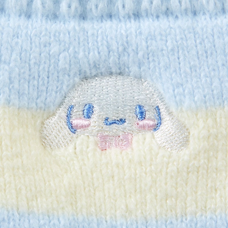 Model wearing striped Sanrio socks with plush cuffs