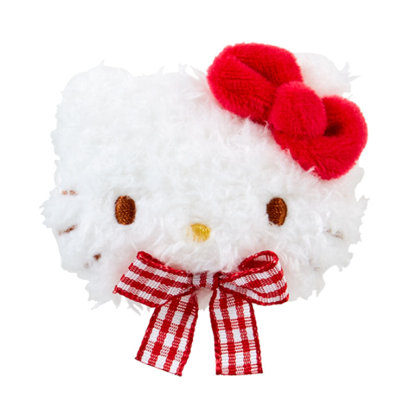 Side view of Hello Kitty plush hair clip resting on marble counter