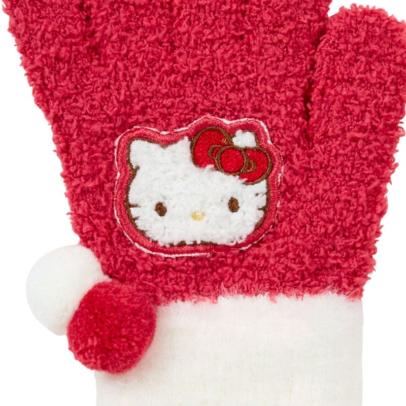 Girl wearing Hello Kitty gloves, smiling in cold weather