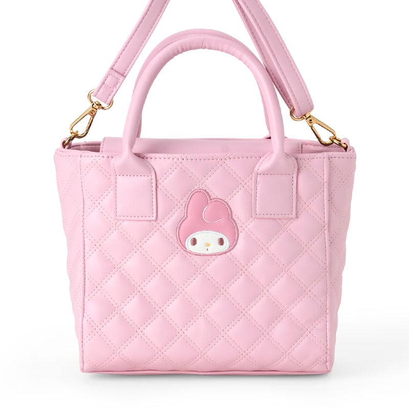 Convertible handbag with adjustable strap worn over the shoulder.