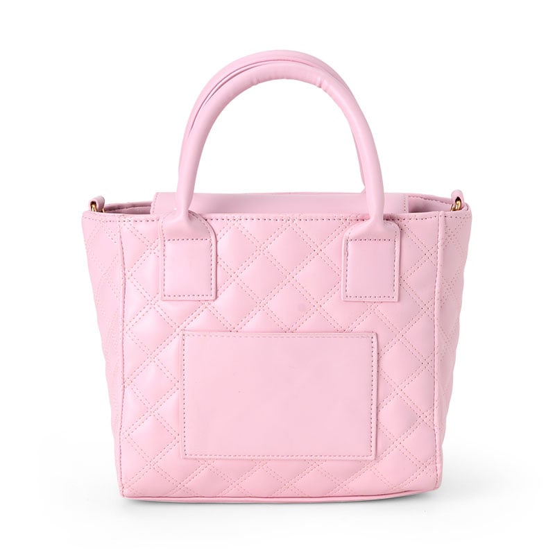 Chic convertible mini quilted tote bag displayed on a table.