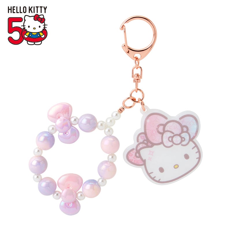 Close-up of hello kitty keychain plush showing bow details and iridescent beads