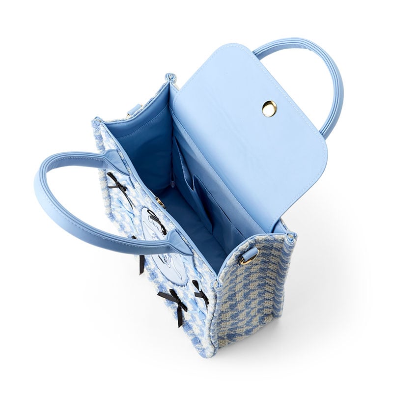 Cinnamoroll bag worn crossbody with adjustable strap in urban setting.