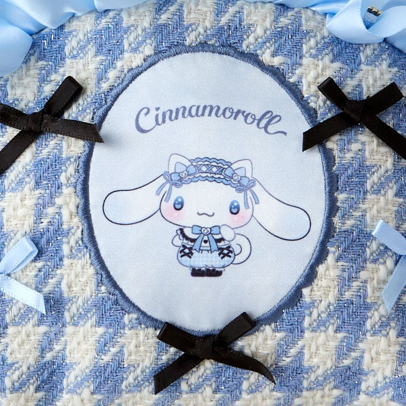 Close-up of the Cinnamoroll mini zipper pouch with ribbon accents and heart zipper pull