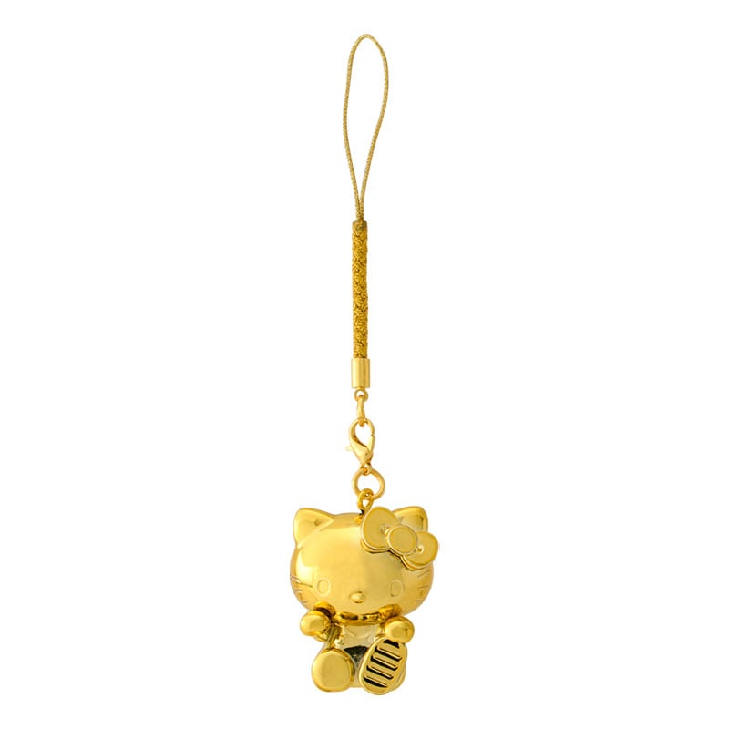 Close-up of gold Hello Kitty zodiac charm with snake-year engraving